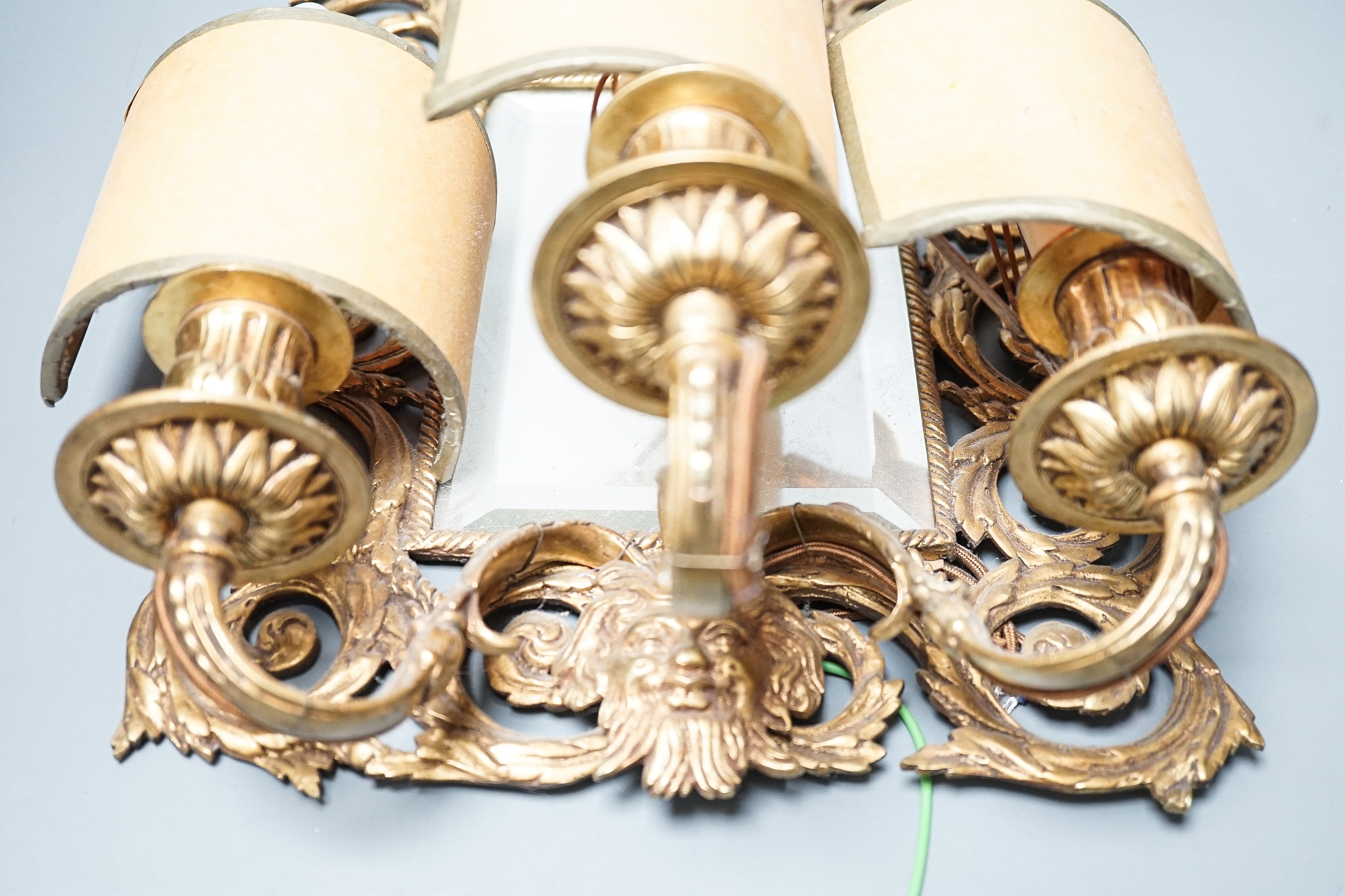 A pair of early 20th century gilt brass girandole mirrors, 39cms high.